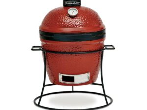 Kamado Joe Grills Joe Jr.® grill With Cast Iron Stand,Inside view of the Joe Jr.® grill,Slo Roller cooking grate,covered girl beside a lounge chair,Ceramic Soapstone,Table that holds a grill